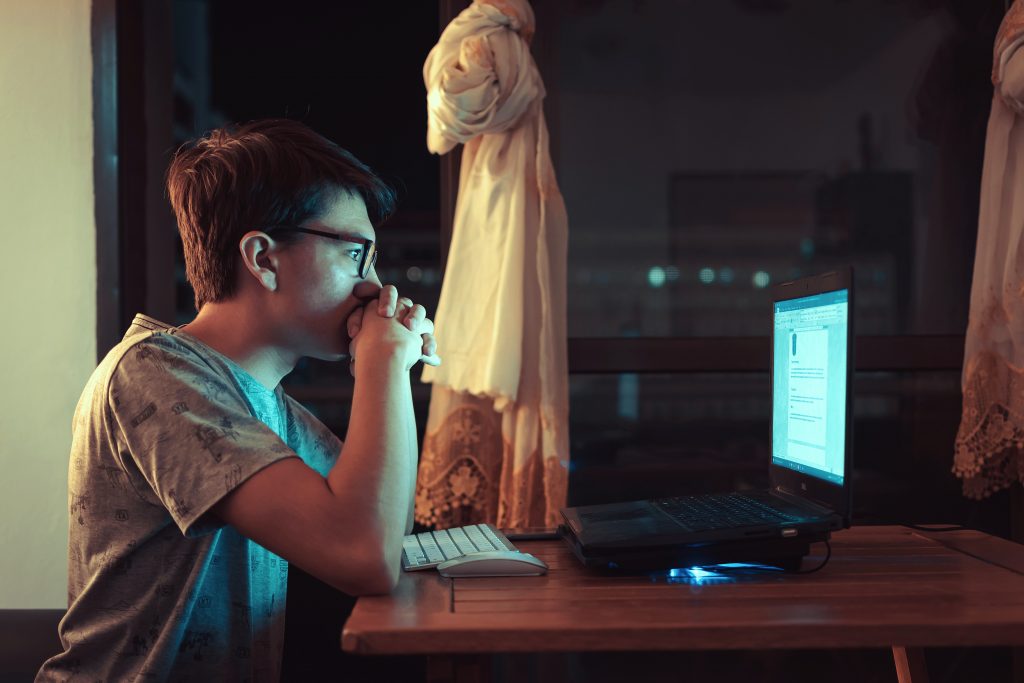 Person reading on a computer at night