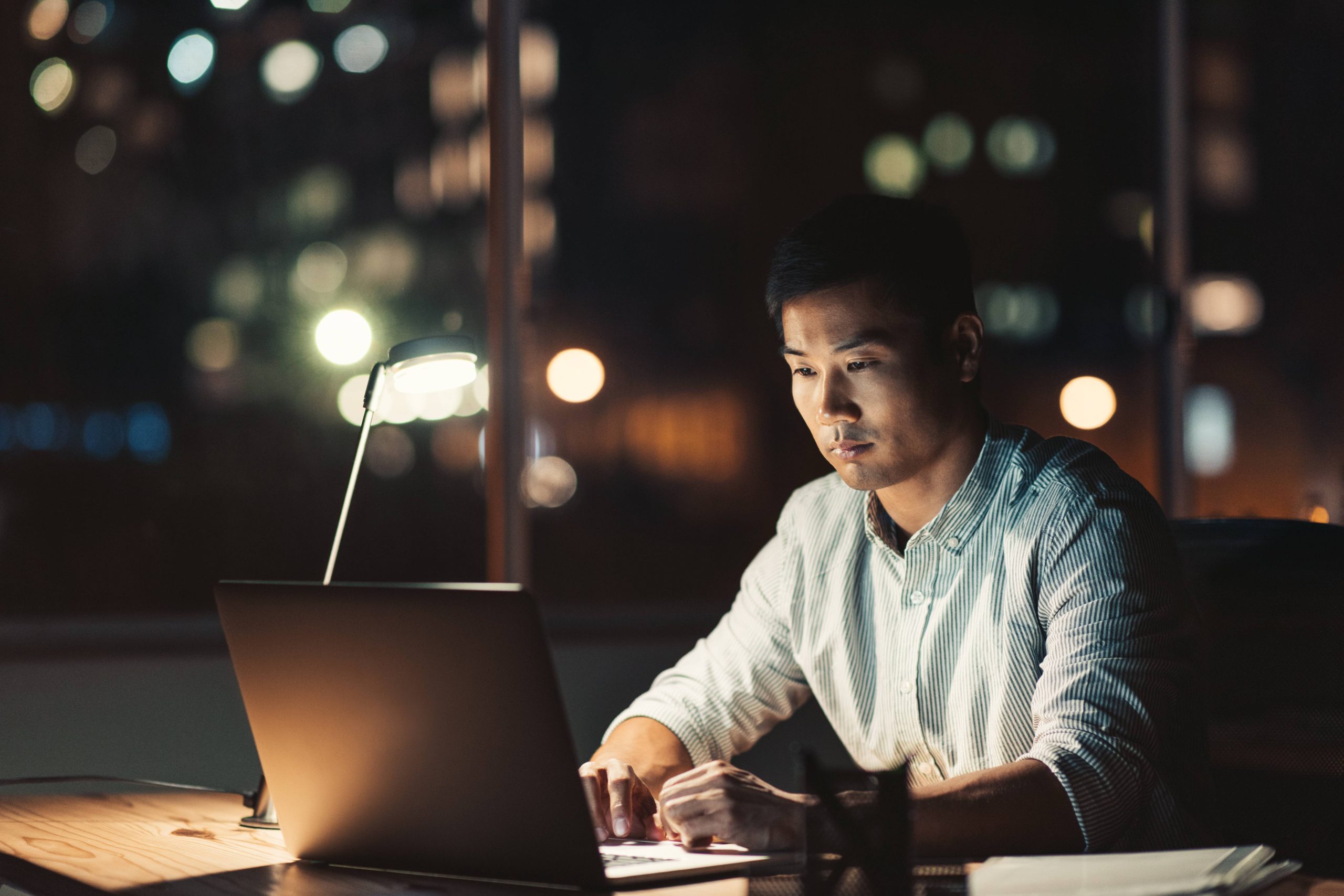 Image showing a man on his laptop late at night.